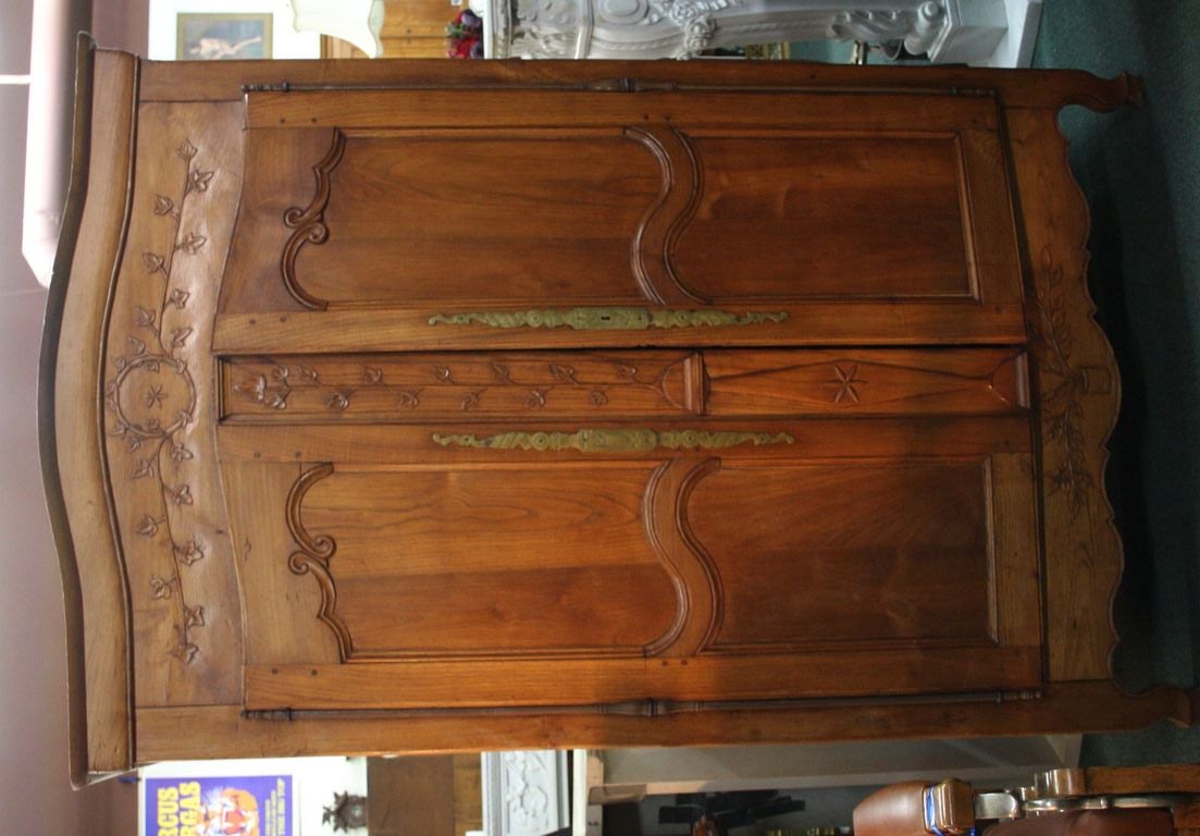 This is a country French armoire circa 1780. It is rather a medium to smaller armoire, please note the dimensions. It retains its original brass hinges, decoration and lock sets. It has a rich warm patina from many years of waxing. It is still